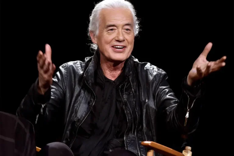 Jimmy Page’s Quiet Heir: What We Know (and Don’t) About James Page Jr. and Sister Scarlet Jimmy Page wearing a black leather jacket gestures with both hands while speaking onstage under dramatic lighting.