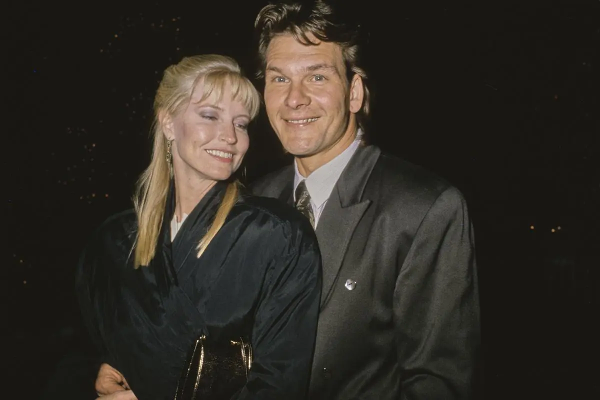 Patrick Swayze and  Lisa Niemi standing closely together at a nighttime event.