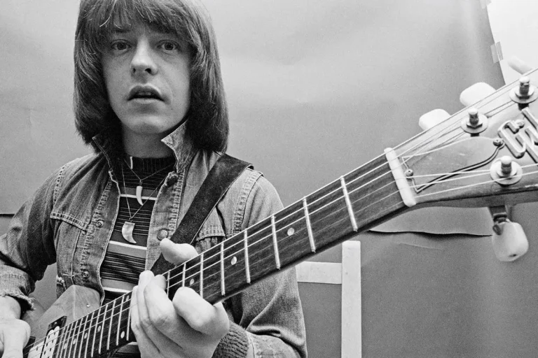 Rick Derringer performing live on stage with electric guitar.