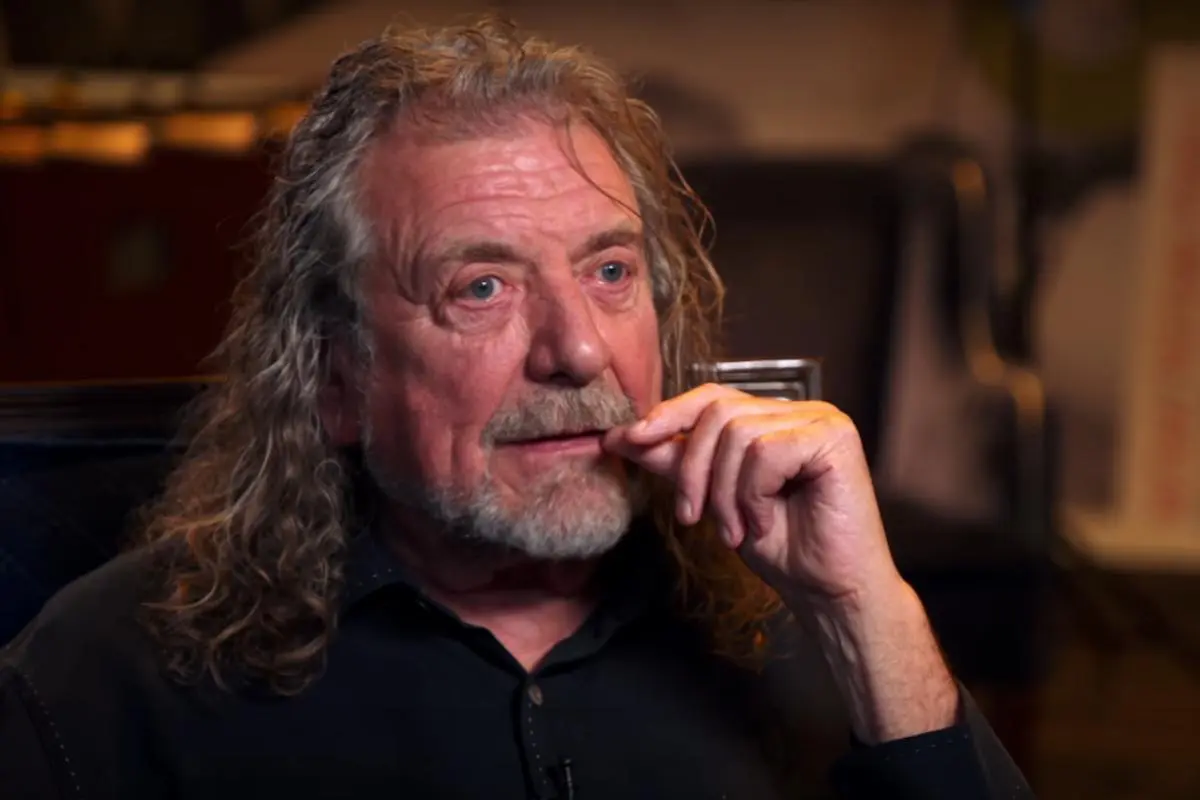 Robert Plant portrait, smiling with curly hair.