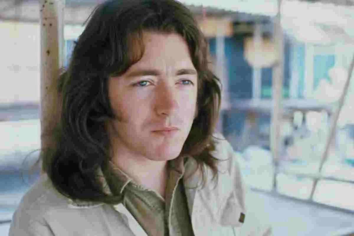 Rory Gallagher performing live on stage with electric guitar