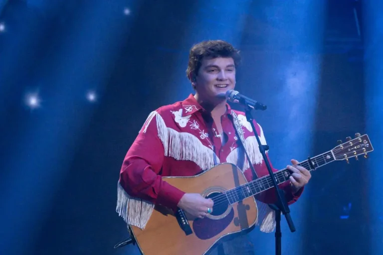 Slater Nalley smiling while performing on stage.
