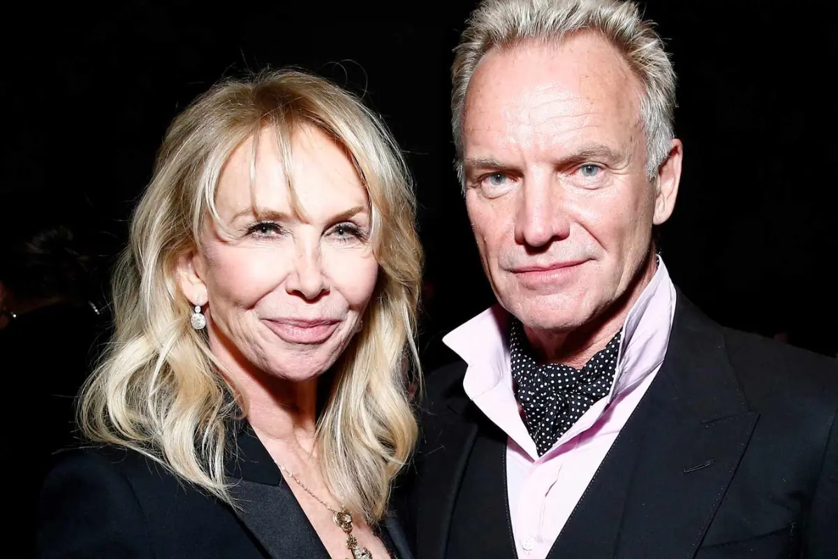 Sting and Trudie Styler stand together at a public event, presenting a composed, united presence as a well-known creative couple.