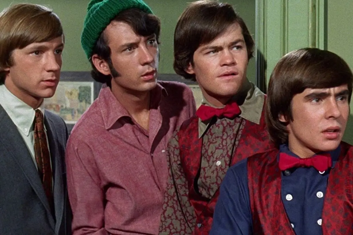 The Monkees appear in character during their television show, capturing the playful, comedic energy that defined their pop culture appeal.