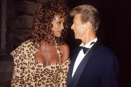 David Bowie couple stands close together at a formal event.