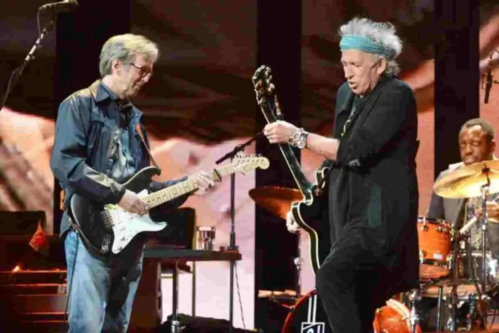 Eric Clapton and Keith Richards performing together on stage during a live concert.
