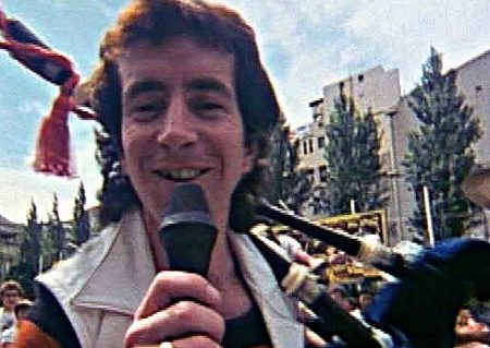 The $479 Bluff: How Bon Scott Faked His Way Onto the Bagpipes Bon Scott playing the bagpipes