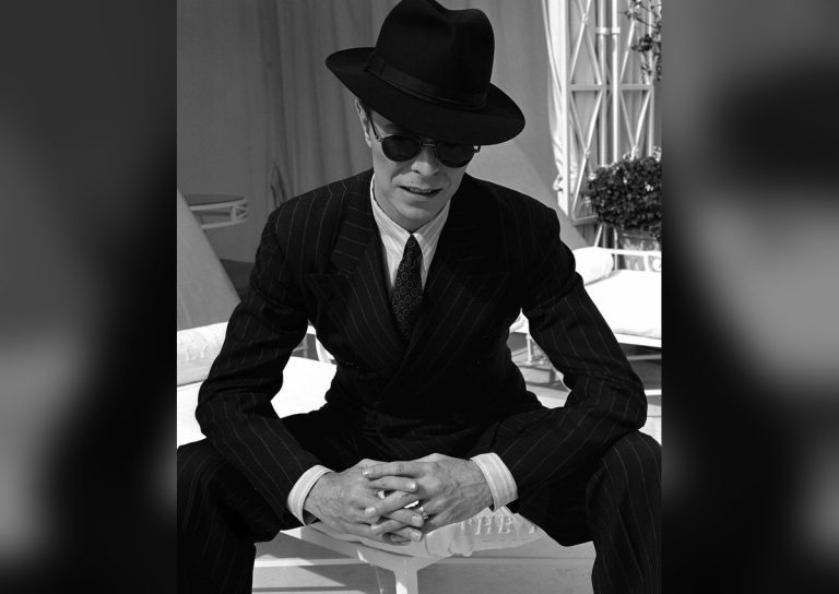 David Bowie in fedora and pinstripe suit as the Thin White Duke era persona