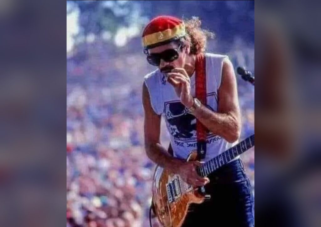 No Album, Wrong Time Slot, Peaking on Mescaline: Santana’s Woodstock Miracle Carlos Santana performing live wearing a headband