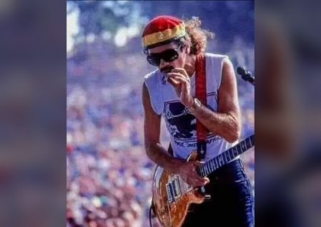 Carlos Santana performing live wearing a headband