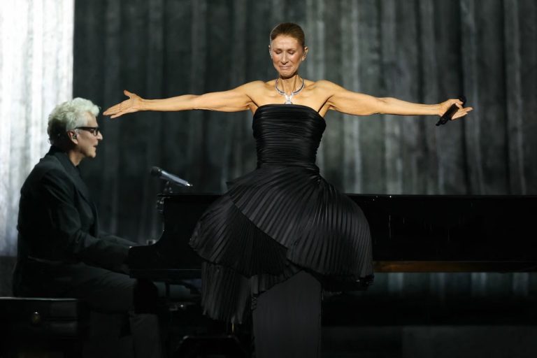 Celine Dion Broke Down Onstage in Paris: ‘I Had Promised Myself Not to Cry’ Celine Dion stands with her arms outstretched on stage in a black pleated gown, visibly emotional, with her pianist at a grand piano behind her