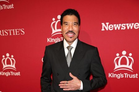 Lionel Richie Has Heart Procedure for AFib, Cancels Three Earth, Wind & Fire Dates Lionel Richie in a black double-breasted suit and patterned tie, smiling on a red carpet at a King's Trust event