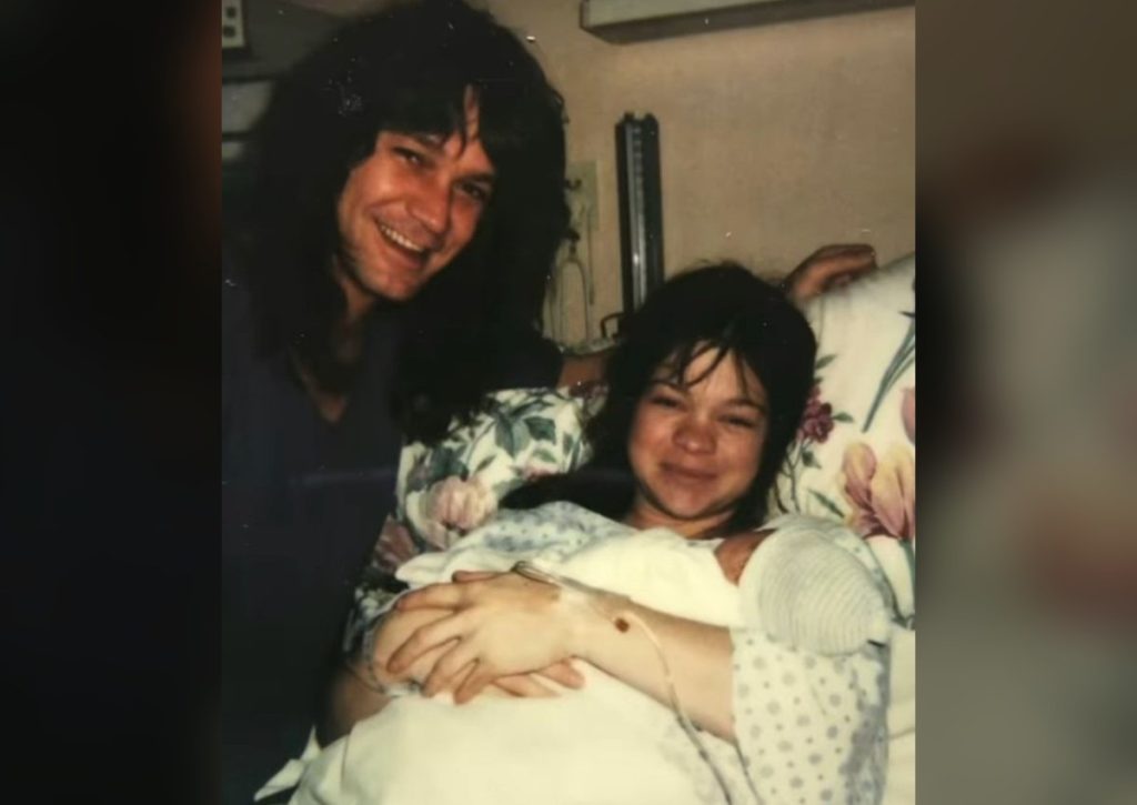 The Baby in the Photo: How Wolfgang Van Halen Went From Eddie’s Arms to Van Halen’s Stage Eddie Van Halen smiling with Valerie Bertinelli and their newborn son Wolfgang at home in 1991