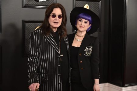 Kelly Osbourne Says Grief After Ozzy’s Death Left Her Unable to Eat — and She Wore a Wig to the Grammys to Hide It Ozzy Osbourne in a pinstriped suit and round sunglasses standing beside his daughter Kelly Osbourne, who wears a wide-brimmed black hat and purple hair, on a Grammy Awards red carpet