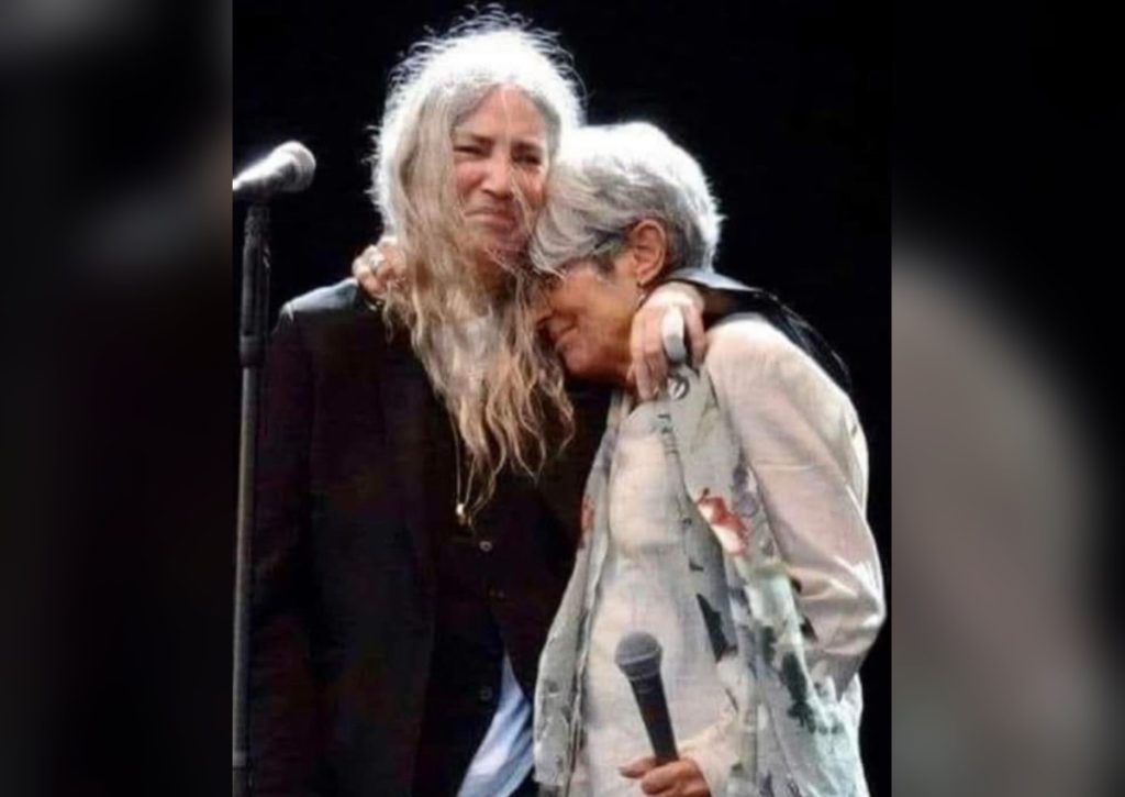 Two Generations, One Dylan Song: The Night Joan Baez Surprised Patti Smith in Cologne Patti Smith embracing Joan Baez on stage in Cologne in 2018