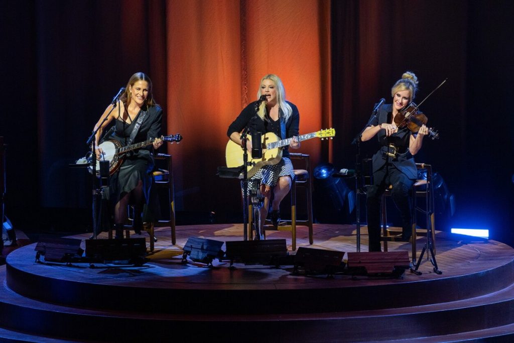 White House Calls Natalie Maines a ‘Despicable Nobody’ With a ‘Peanut-Sized Brain’ After Her Anti-Trump Tour Remarks Emily Strayer, Natalie Maines and Martie Maguire of The Chicks performing seated on stage at Chicago's Auditorium Theatre, October 2026