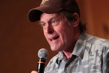 Ted Nugent Says Eliminating the Democratic Party Is ‘the Goal’ at Trump’s Kansas Rally, as Trump Praises Him Ted Nugent in a brown cap and camouflage shirt speaking into a microphone