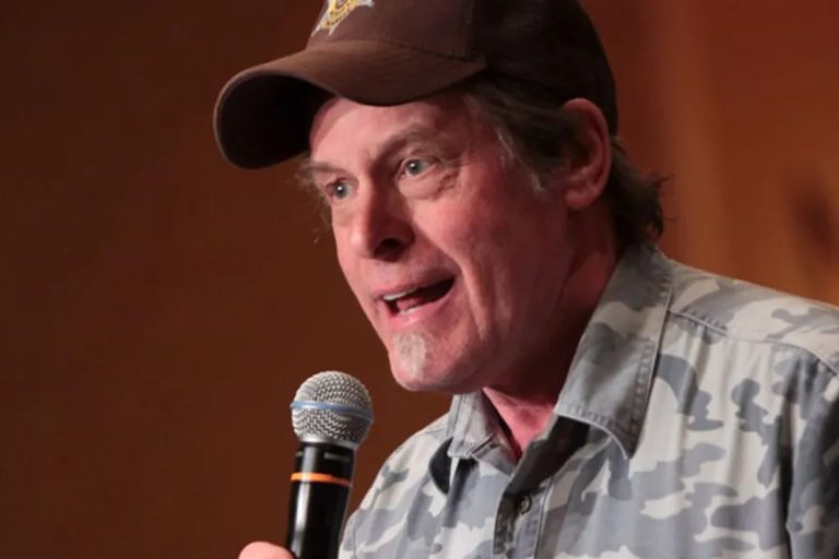 Ted Nugent Says Eliminating the Democratic Party Is ‘the Goal’ at Trump’s Kansas Rally, as Trump Praises Him Ted Nugent in a brown cap and camouflage shirt speaking into a microphone
